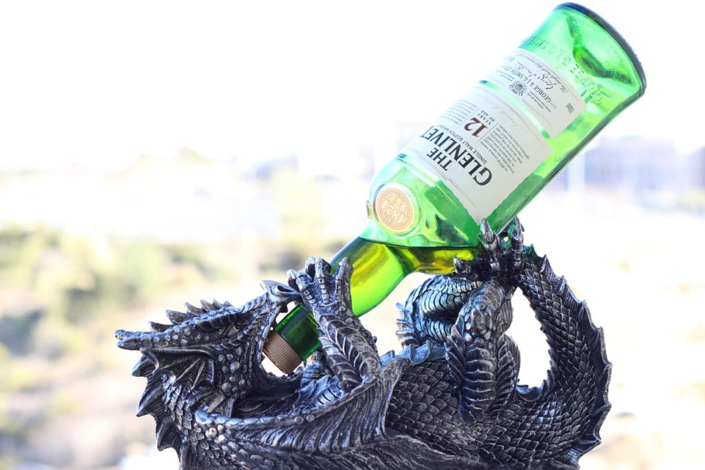 Scotch Gifting Guide - Dragon holding single malt scotch bottle
